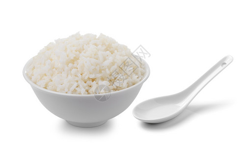 白色背景中盛满米饭和勺子的碗图片