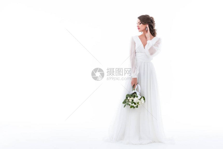穿着优雅的白色礼服和婚纱花束装扮新娘图片