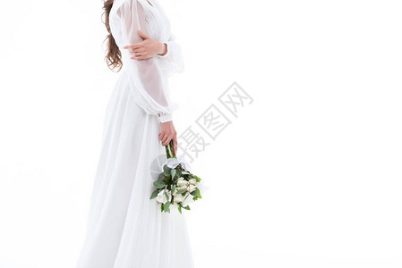 以传统礼服和婚纱花束的新娘图片