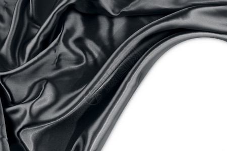 纯色背景上波纹黑色丝织物的特写背景图片