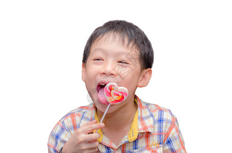 小亚洲小男孩手里吃糖果孤立图片