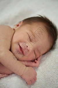 快乐的笑喜乐睡着的新生儿宝图片