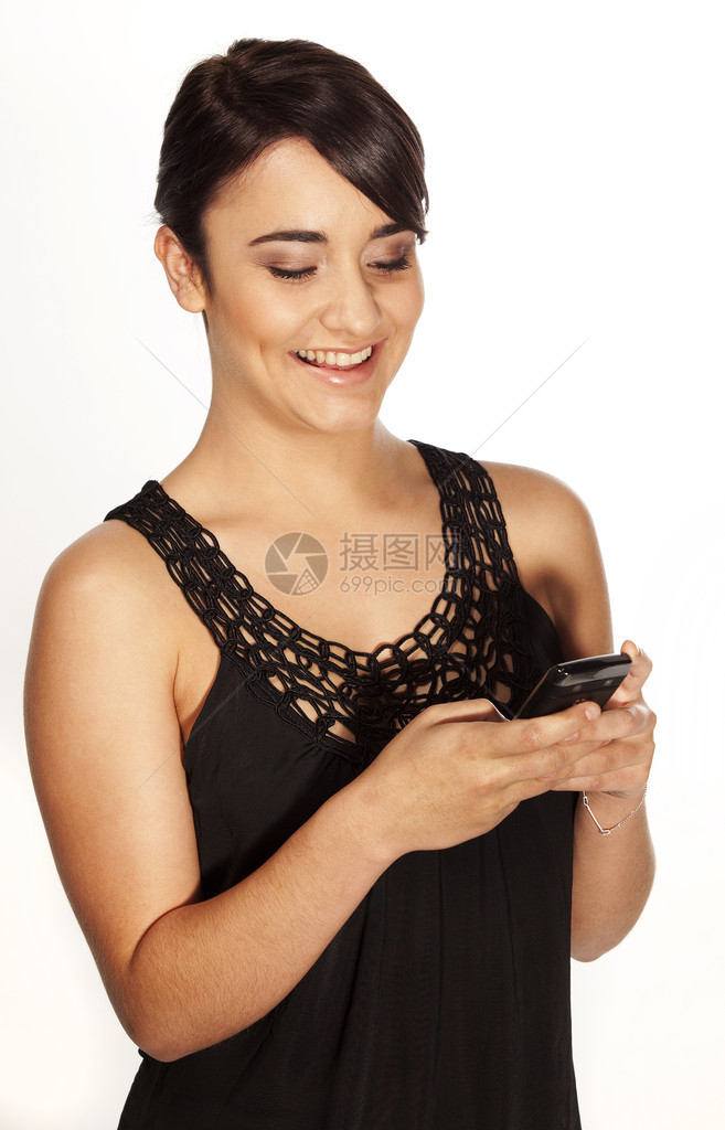 迷人的年轻女子从她的手机智能手图片