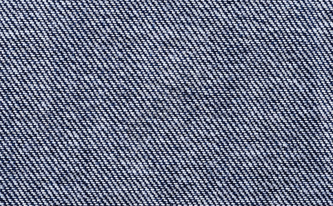 蓝色牛仔布纺织宏观照片坚固的棉经面织物表面斜纹织物背景图片
