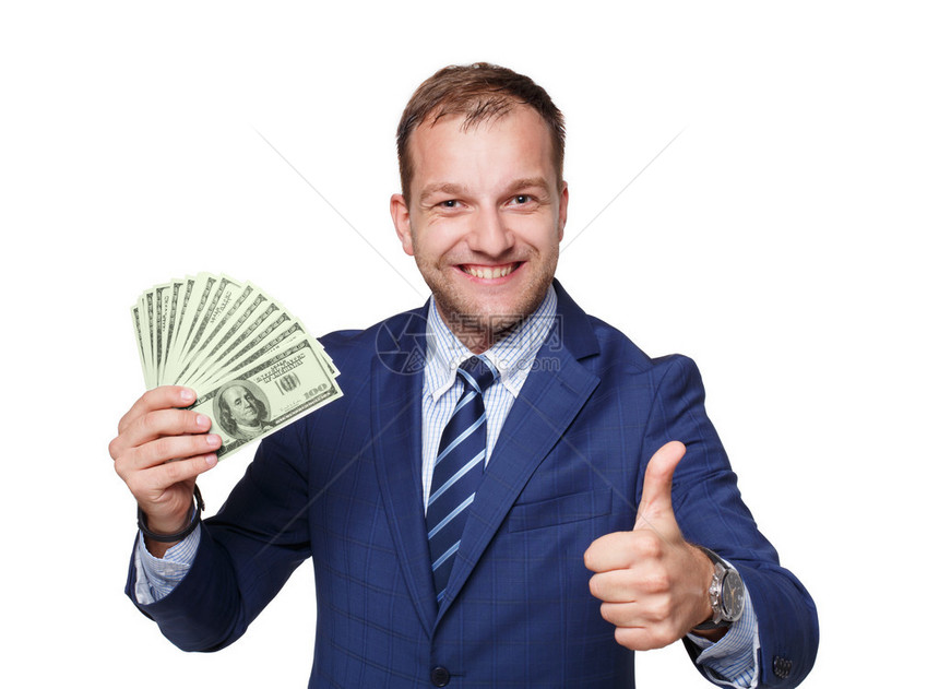 显示金钱美元爱好者的一个英俊的人画象反对白色背景拿着一包美国货币的商人出现了大拇指商业和金融成功图片