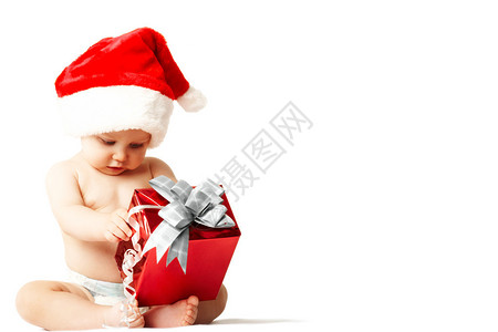 圣诞老人帽中好奇和惊讶的婴儿图片
