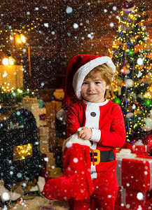 童年时光孩子男孩拿着圣诞礼物圣诞袜概念孩子开朗的脸在圣诞袜里得到了礼物圣诞袜的内容哦背景图片