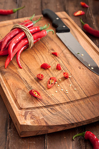 在木菜板上切红辣椒图片