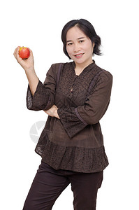 中年亚洲妇女拿着苹图片