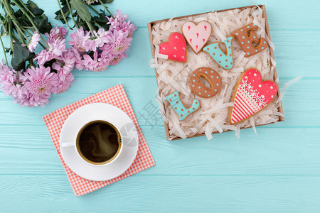 情人节礼物盒里的爱饼干一杯黑咖啡饼干和木制背景上的鲜花早上好背景图片