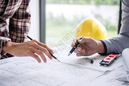 建筑工程或建筑师在工作现场检查建筑项目的绘图和素描信图片