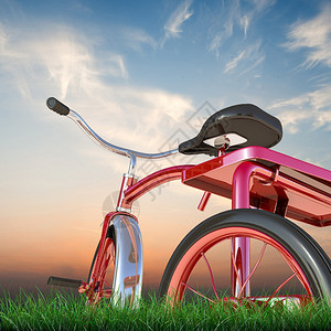 绿草地上的红色三轮车图片