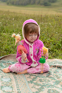夏天在草地上玩洋娃的女孩图片