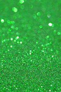 抽象的绿色闪光背景纹理与闪发光的星圣诞细节与模糊区域艺术彩色背景图片
