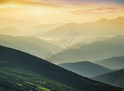 日出时山丘在山峰谷美图片