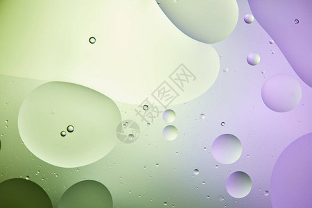 淡绿色和紫色混合水和油的抽象背景以图片