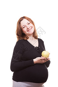 孕妇手里拿着一个苹果对着镜头微笑在白图片