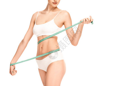 妇女腰部与白色隔离的测量胶背景图片