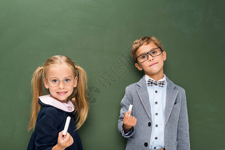 黑板旁边有粉笔的可爱学生图片