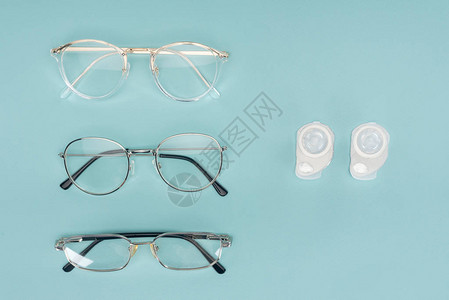 以蓝底排列的玻璃眼镜和隐形眼镜图片