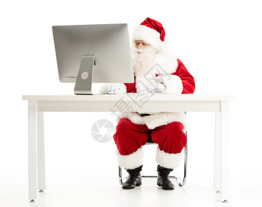 圣诞老人用严肃的表情看电脑监视器背景图片