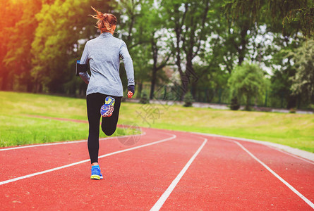 运动妇女沿轨背影跑步健康的健图片