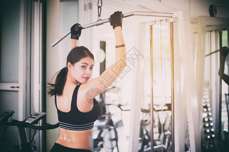 美丽的肌肉适合女人锻炼肌肉和健身女人在健身房锻炼健身健康生活方式的图片