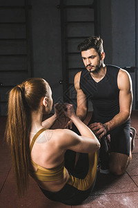 男教练员帮助年轻女运动员在图片