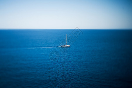 豪华游艇在热带平静的海面上航行移轴镜头用于突出小船并与大海相比强图片