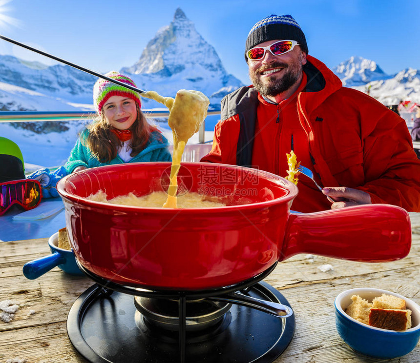 瑞士美食晚宴享受午休的家庭滑雪者山观图片