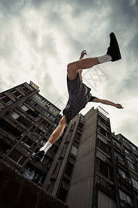 年轻人在城市春日做跑酷跳跃图片