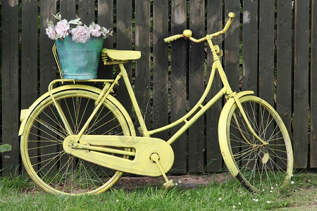 丹麦木栅栏前的黄色自行车图片