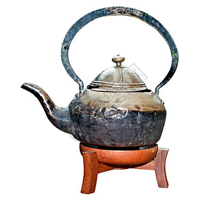 古老的茶壶在木材支撑图片