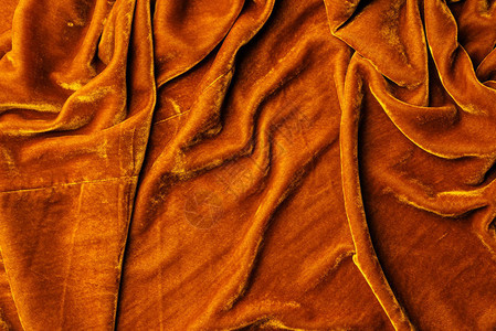 橙色天鹅绒纺织品为背图片