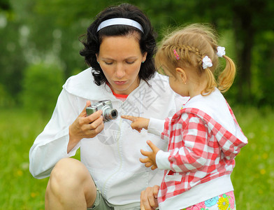 母亲和女儿一起拍照妈教年轻女儿在户外拍背景图片