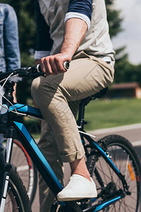 男子在夏季公园骑自行背景图片