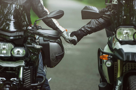 两个摩托车手牵着手图片