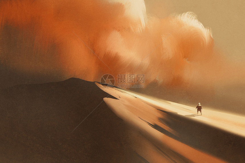 沙漠中的沙尘暴和登山男子i图片