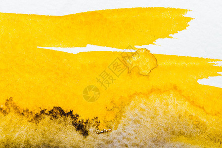 白纸上黄色水彩溢出的顶视图图片