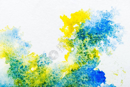 白色背景上的蓝色和黄色水彩色溢图片