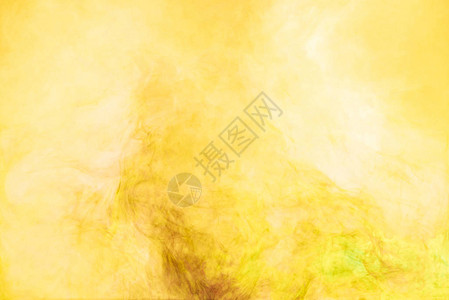 黄色油漆飞溅的特写视图背景图片