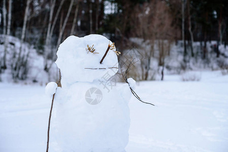 雪人以冬季森林为背景图片