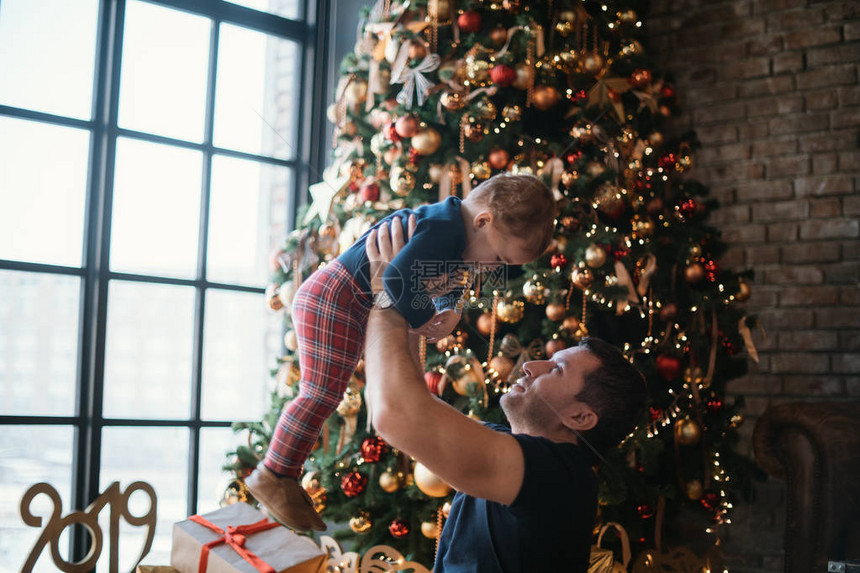 爸和宝在家里的新年树上玩耍图片