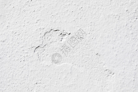水泥砖表面的白墙裂缝背景图片