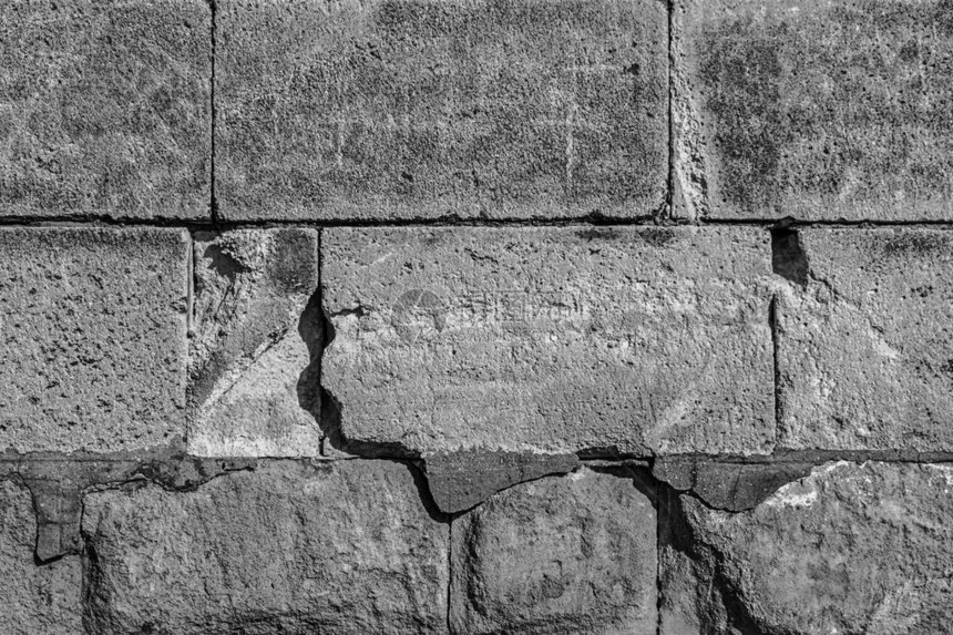 不均匀的旧石墙保护灰色石头鹅卵石基地设计单色图片