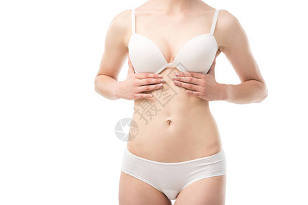 在胸罩上做乳房自我检查的年轻女部分视力孤背景图片