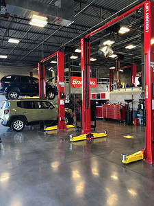 配备专用维修设备的汽车维修服务店在维修中心的维修区技术人员汽车修理厂背景图片