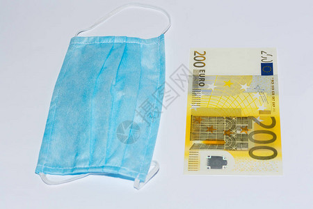 保护医疗面具和白色背景的欧元帐单图片