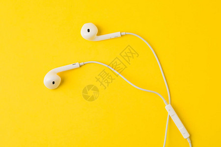 黄色背景的白色耳机音乐概念图片