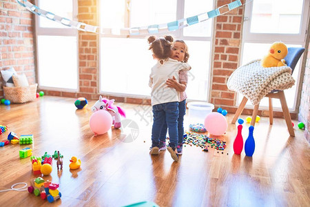 幼稚园时可爱的幼儿们围抱着许多玩具在图片